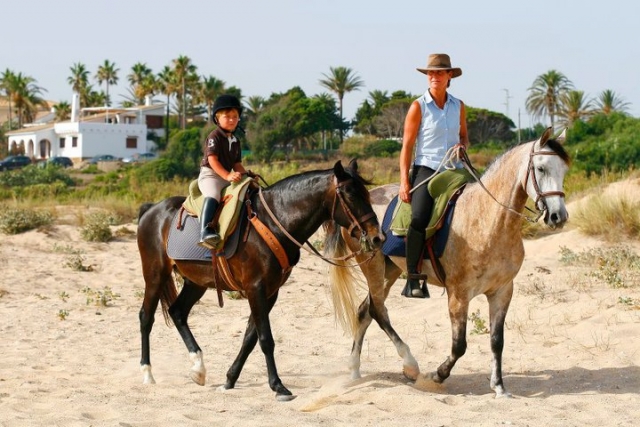 Adult and child riding in countryside