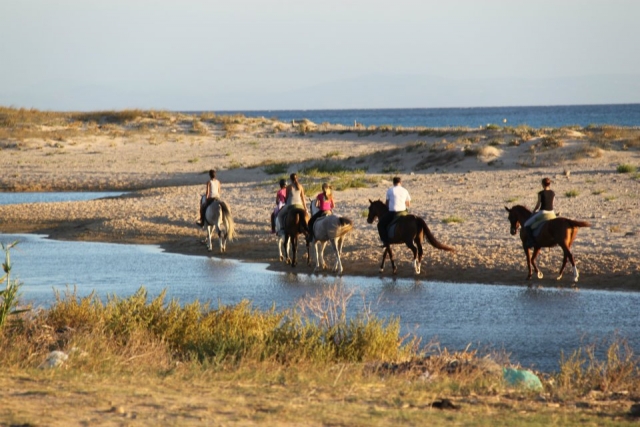 Group of riders crossing stream